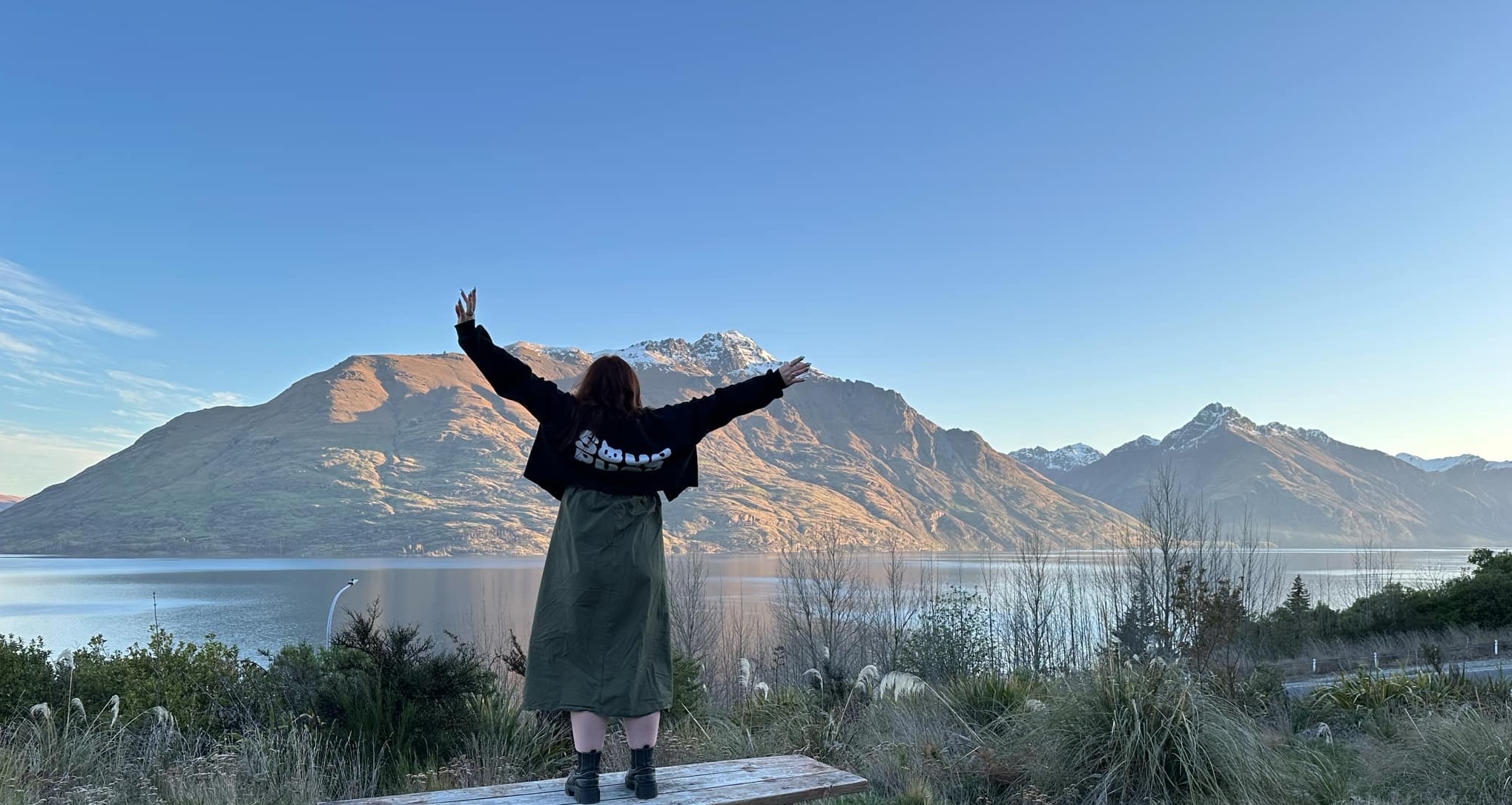 Image of Sally in Queenstown New Zealand looking out at the snow top mountains